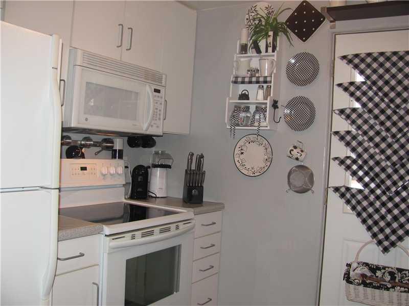 3 Robinhood Road Green Tree, PA 15220 - Photo 14 of 25 Kitchen. Refrigerator, Electric Stove, Microwave, Dishwasher, Disposal and Ceramic Floor. The door opens to the Wrap Around Deck.