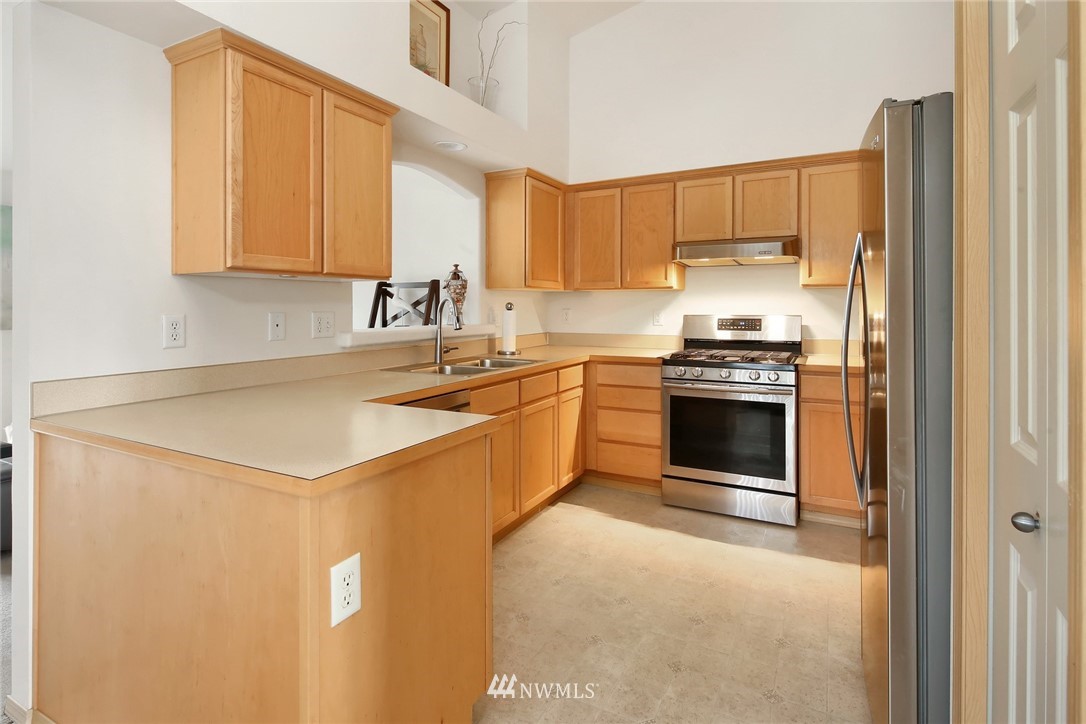 7503 Seashell Way Blaine, WA 98230 - Photo 12 of 31 a kitchen with stainless steel appliances a stove a sink and a refrigerator