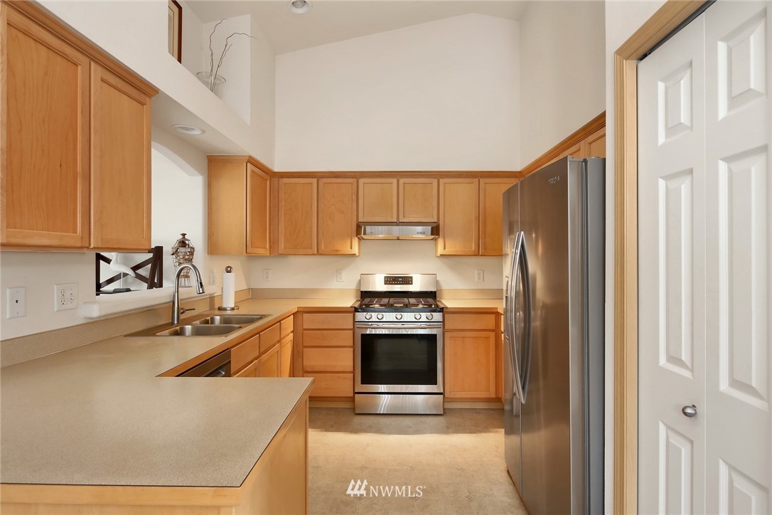 7503 Seashell Way Blaine, WA 98230 - Photo 13 of 31 a kitchen with stainless steel appliances granite countertop a sink stove and refrigerator