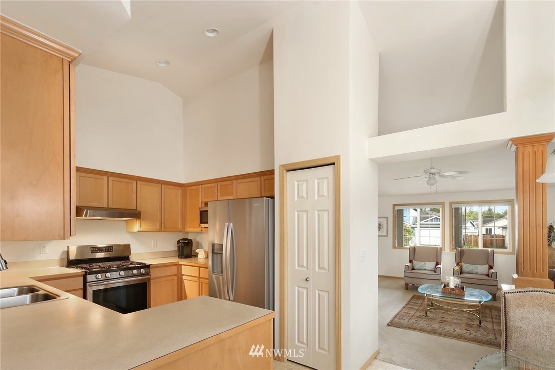7503 Seashell Way Blaine, WA 98230 - Photo 14 of 31 a kitchen with stainless steel appliances a refrigerator and a stove top oven
