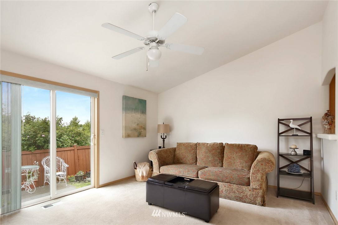 7503 Seashell Way Blaine, WA 98230 - Photo 18 of 31 a living room with furniture and a floor to ceiling window