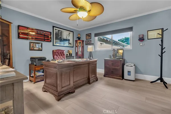 a spacious bedroom with a bed and ceiling fan