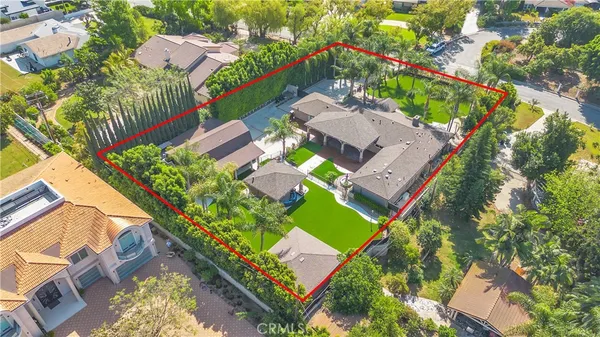 an aerial view of a house with a yard and garden