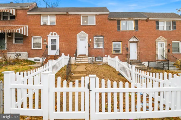 a view of a brick building next to a yard