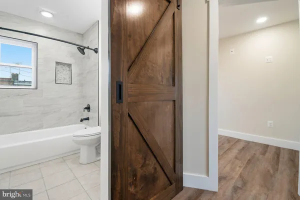 a bathroom with a toilet a sink and bathtub