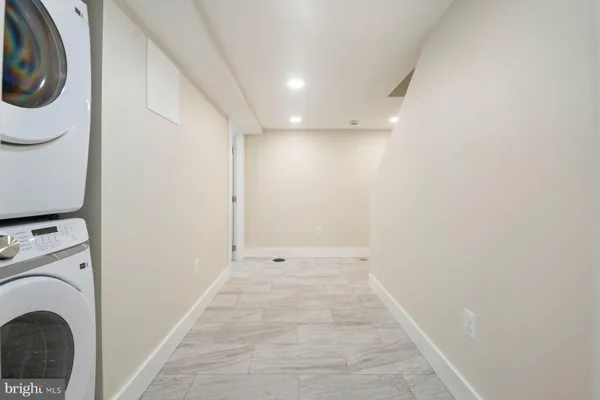 a view of a hallway with washer and dryer