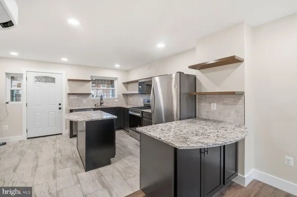 a kitchen with refrigerator and wooden cabinets