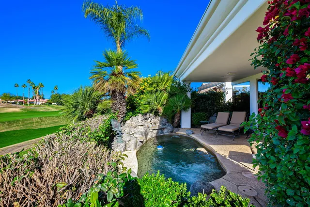 a view of a table and chairs in the garden