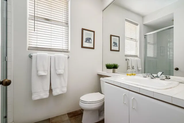 a bedroom with two bed and a window