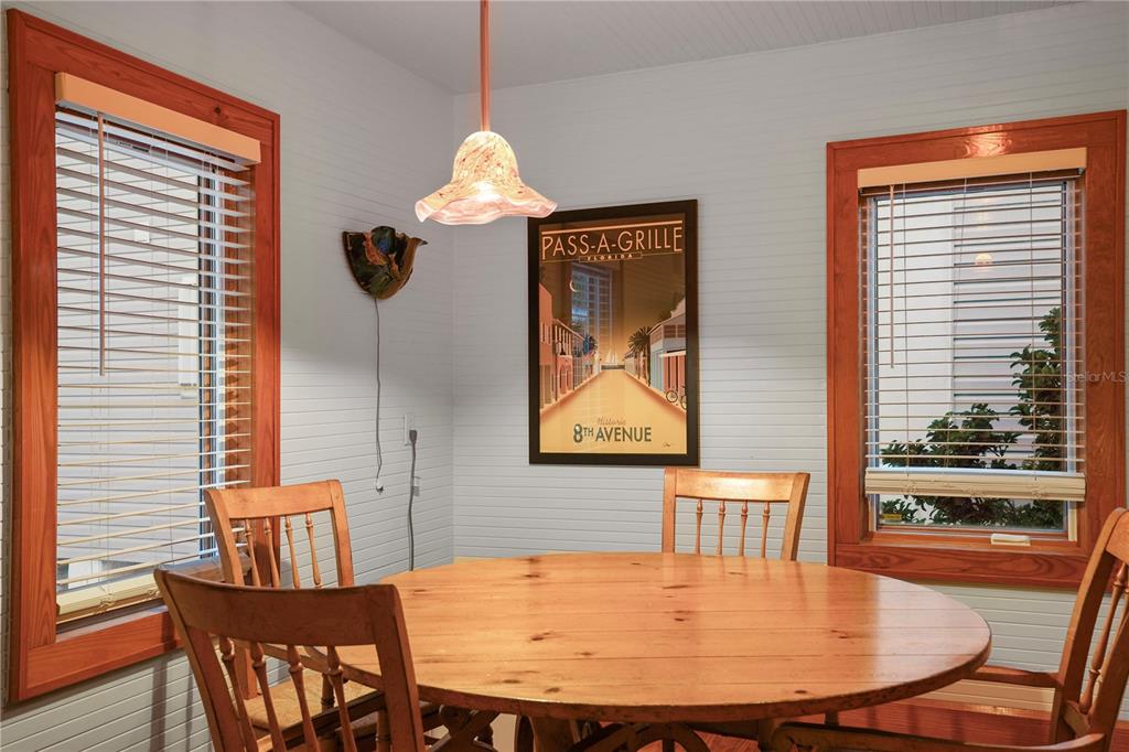 702 Pass A Grille Way St. Pete Beach, FL 33706 - Photo 29 of 41 a view of a dining room with furniture and wooden floor