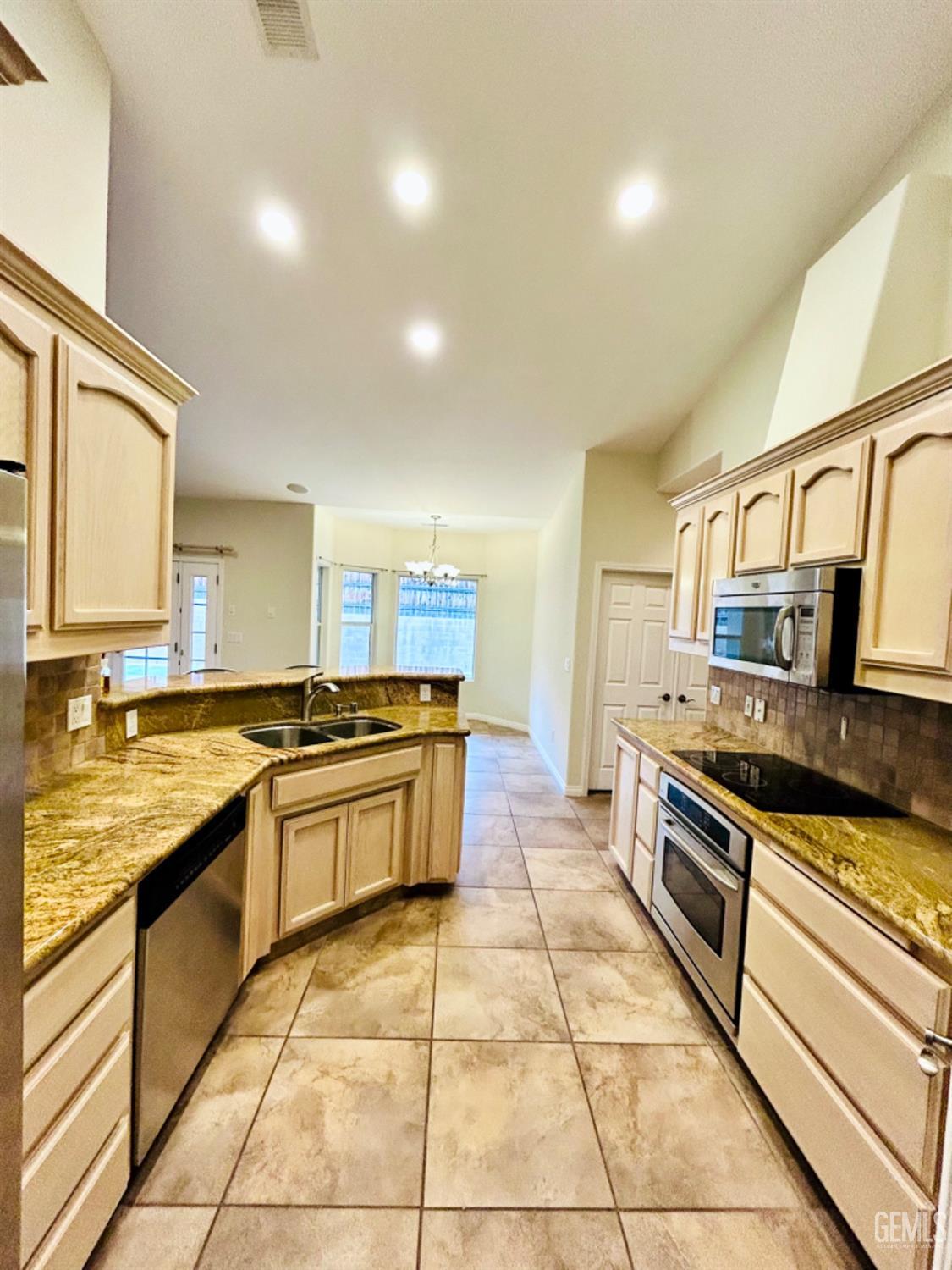 Undisclosed Address Taft, CA 93268 - Photo 15 of 27 a large kitchen with stainless steel appliances granite countertop a stove and a sink