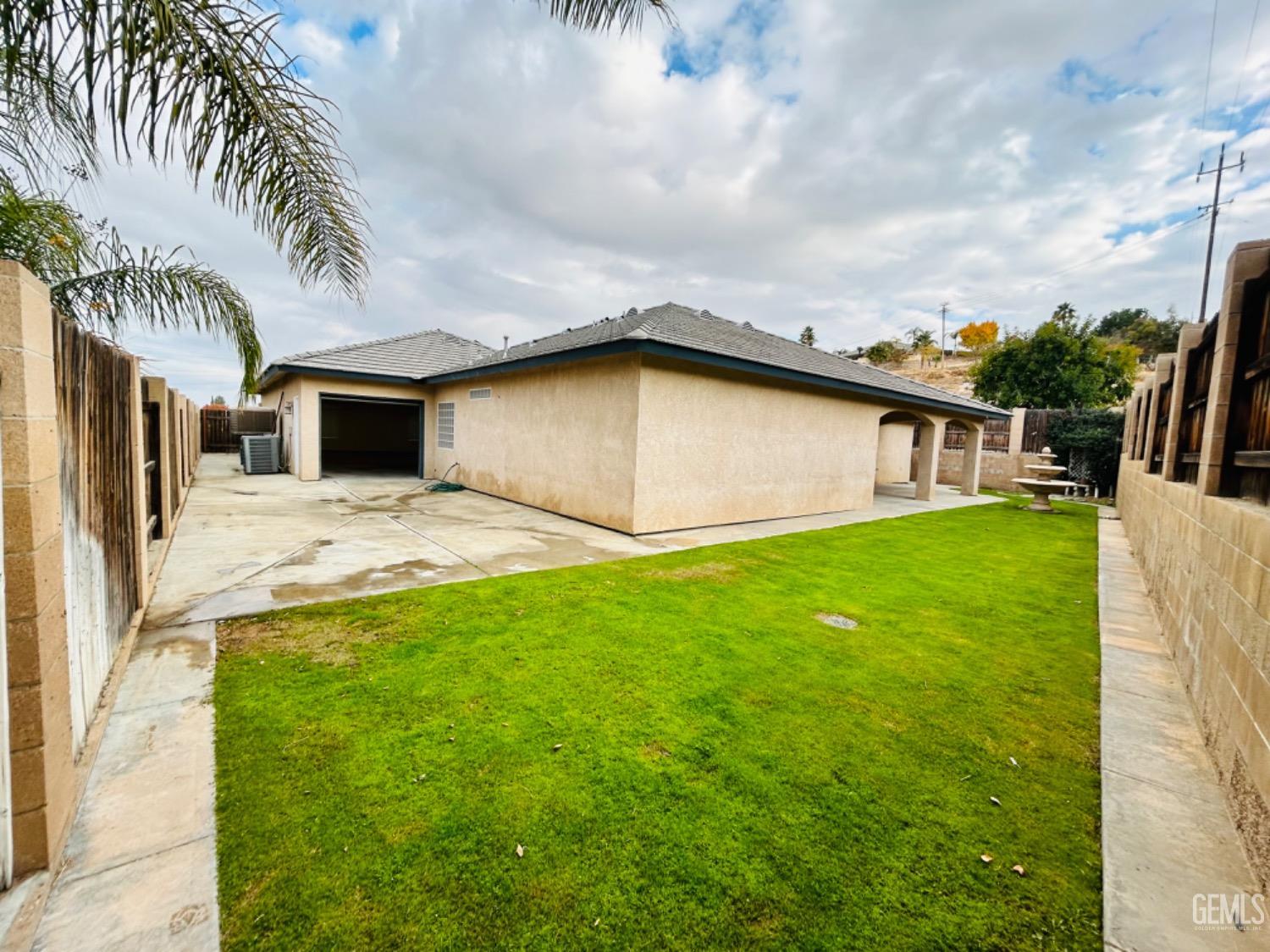 Undisclosed Address Taft, CA 93268 - Photo 7 of 27 a view of a backyard with plants and patio