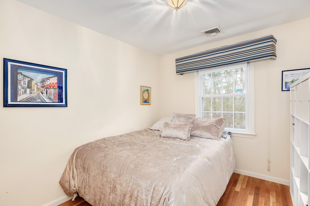 830 Worcester Street Wellesley, MA 02482 - Photo 19 of 30 a bedroom with a bed and a large window