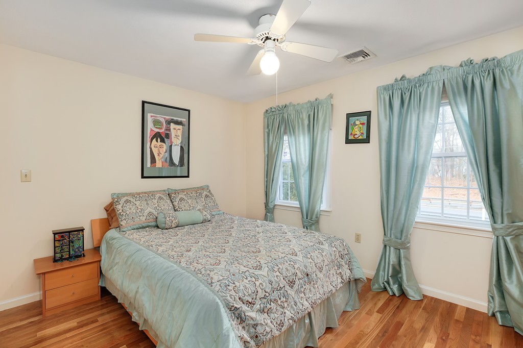 830 Worcester Street Wellesley, MA 02482 - Photo 20 of 30 a bedroom with a large bed and a window