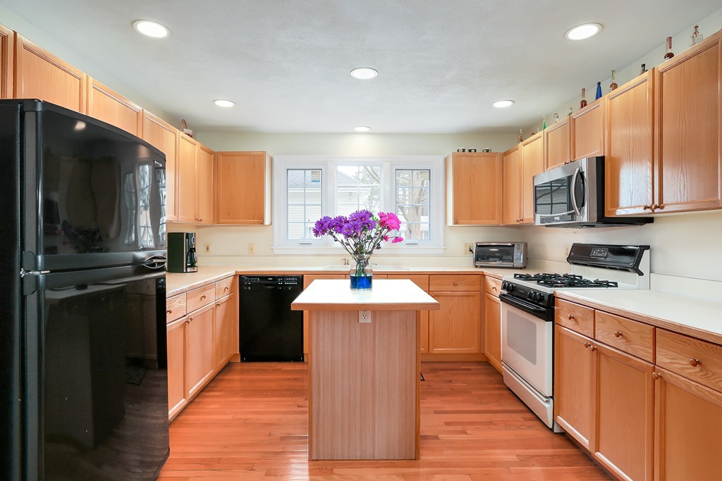 830 Worcester Street Wellesley, MA 02482 - Photo 6 of 30 a kitchen with stainless steel appliances a refrigerator sink and cabinets