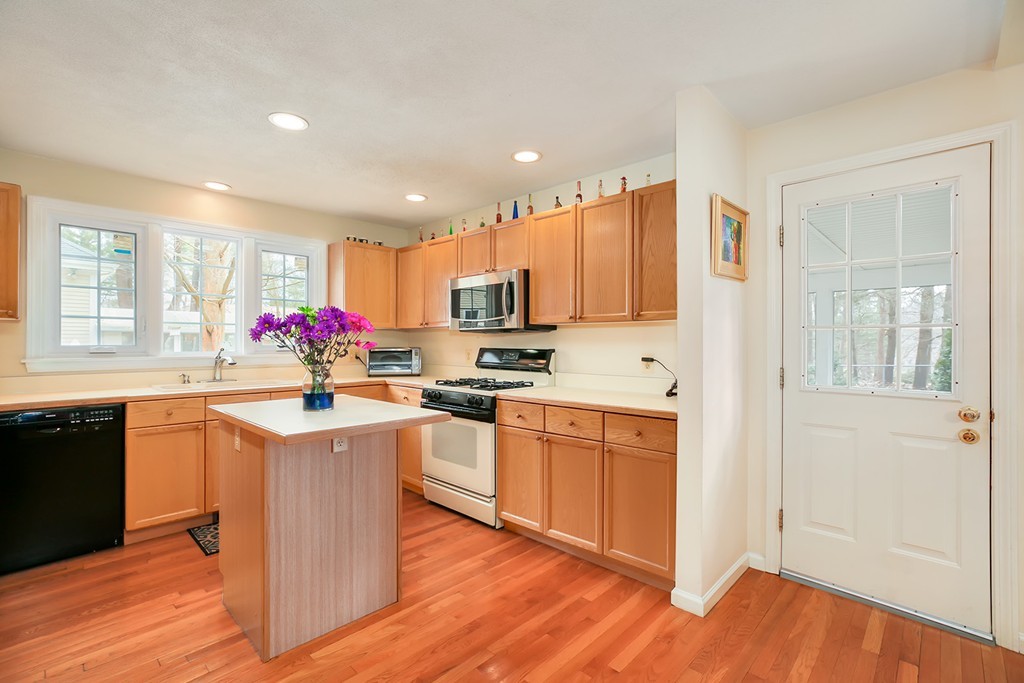 830 Worcester Street Wellesley, MA 02482 - Photo 8 of 30 a kitchen with stainless steel appliances granite countertop a sink stove and refrigerator