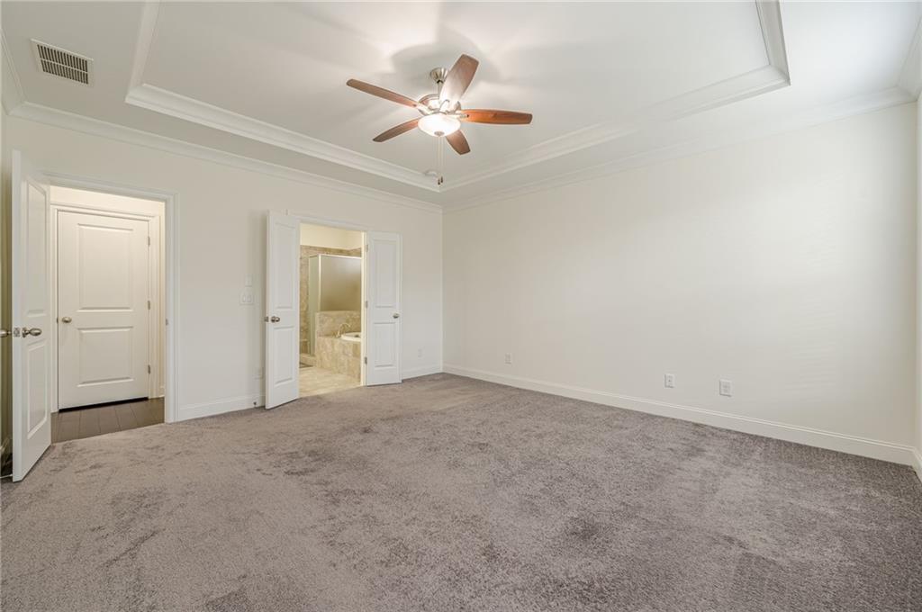 1040 Peyton View Court Alpharetta, GA 30004 - Photo 12 of 53 an empty room with chandelier fan and windows