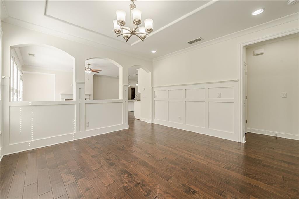 1040 Peyton View Court Alpharetta, GA 30004 - Photo 18 of 53 wooden floor in an empty room with a chandelier