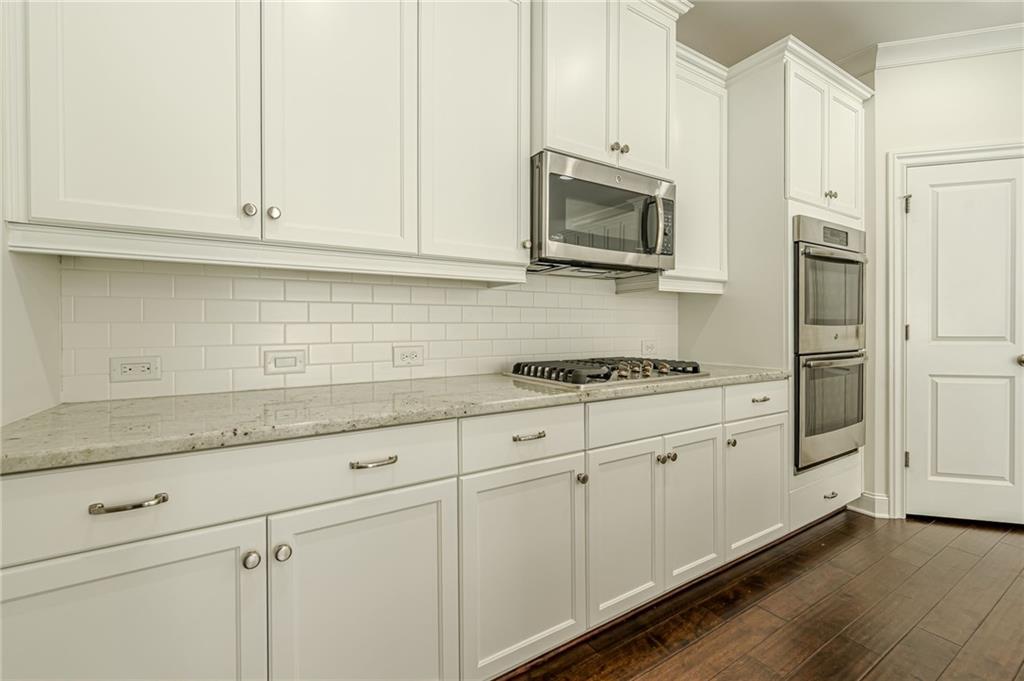 1040 Peyton View Court Alpharetta, GA 30004 - Photo 23 of 53 a kitchen with stainless steel appliances granite countertop white cabinets a sink and dishwasher