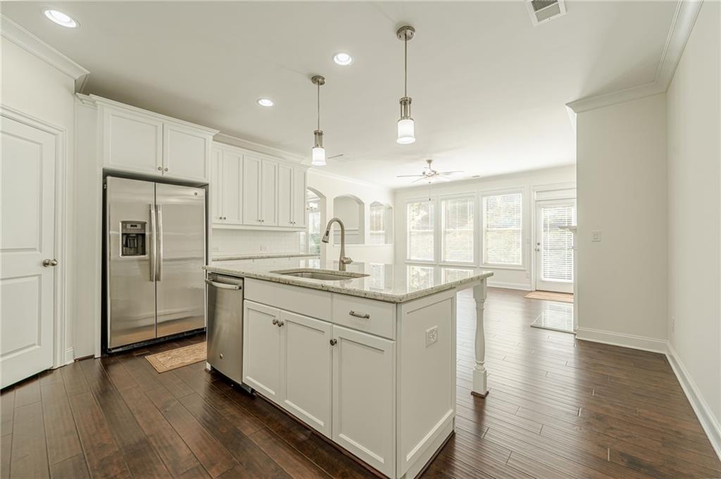 1040 Peyton View Court Alpharetta, GA 30004 - Photo 24 of 53 a kitchen with granite countertop a sink a counter space and stainless steel appliances