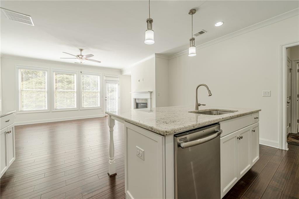 1040 Peyton View Court Alpharetta, GA 30004 - Photo 25 of 53 a kitchen with stainless steel appliances granite countertop a sink a stove and a wooden floors