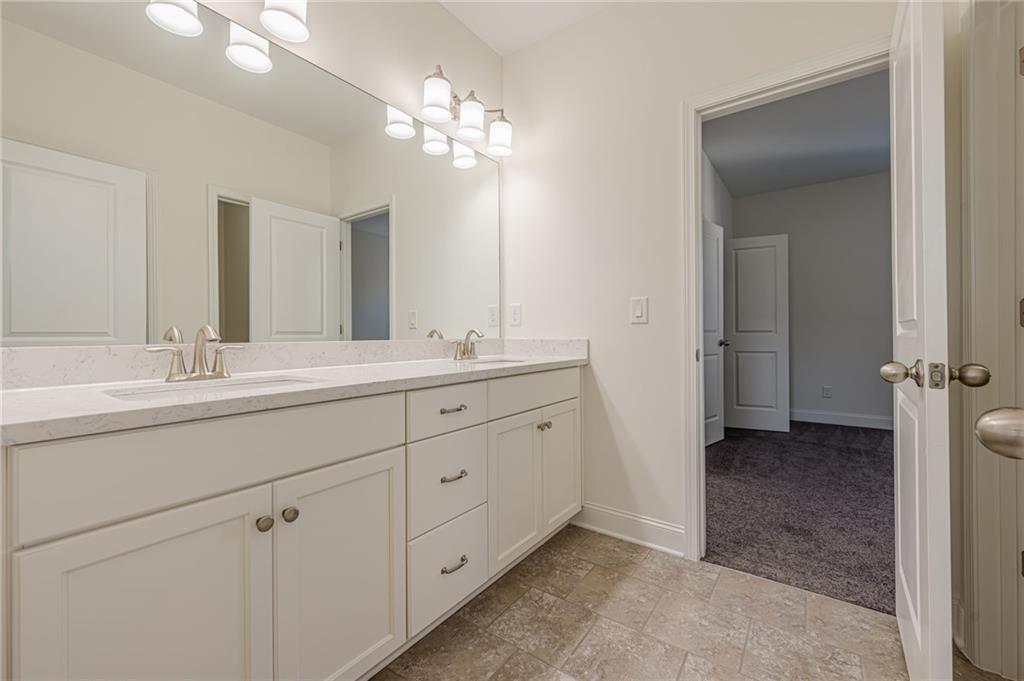 1040 Peyton View Court Alpharetta, GA 30004 - Photo 36 of 53 a bathroom with a double vanity sink and a mirror