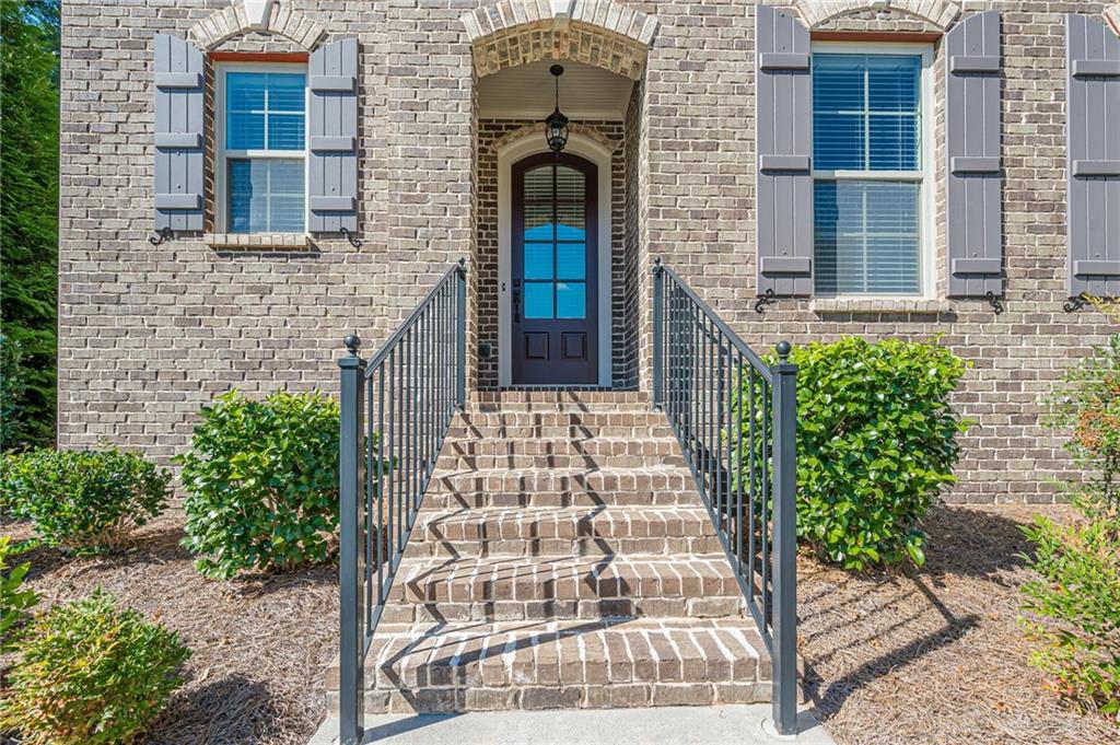 1040 Peyton View Court Alpharetta, GA 30004 - Photo 7 of 53 a front view of a house with a garden