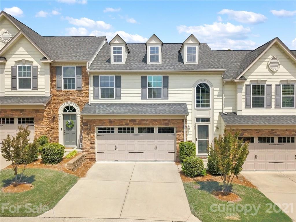 107 Inlet Point Drive Tega Cay, SC 29708 - Photo 1 of 24 a front view of a house with garden