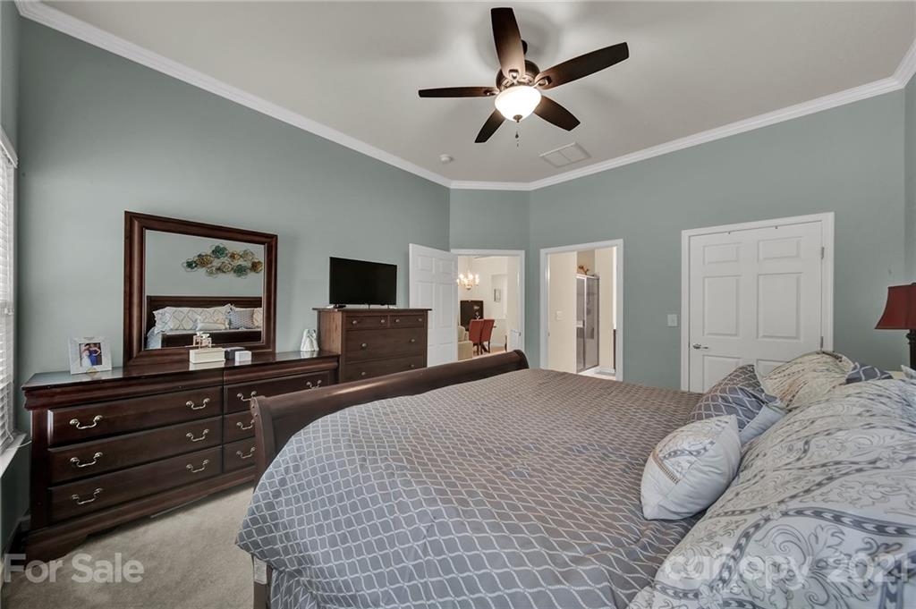 107 Inlet Point Drive Tega Cay, SC 29708 - Photo 11 of 24 a bedroom with a bed and a flat screen tv