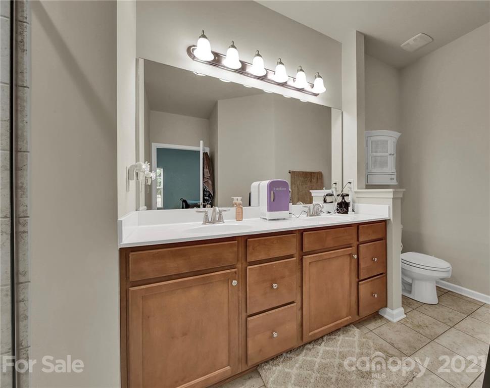 107 Inlet Point Drive Tega Cay, SC 29708 - Photo 12 of 24 a bathroom with a double vanity sink and a toilet