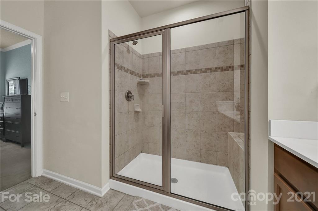 107 Inlet Point Drive Tega Cay, SC 29708 - Photo 13 of 24 a bathroom with a glass shower door