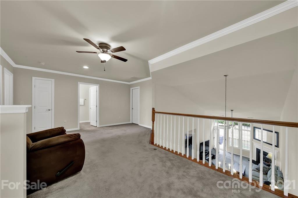 107 Inlet Point Drive Tega Cay, SC 29708 - Photo 14 of 24 a living room with furniture and a chandelier