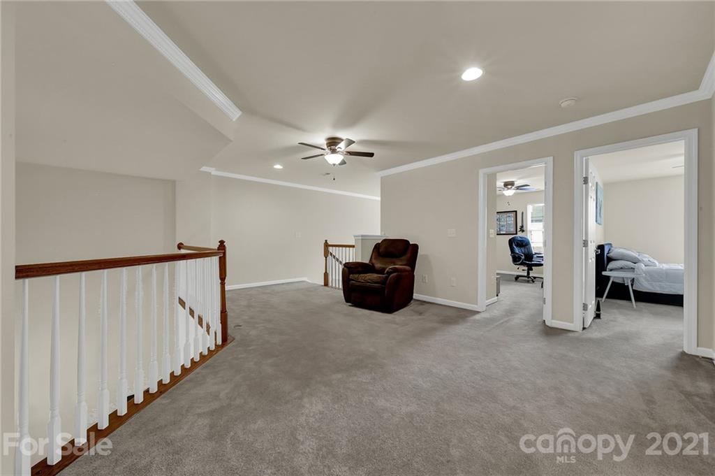 107 Inlet Point Drive Tega Cay, SC 29708 - Photo 15 of 24 a living room with furniture and a chandelier