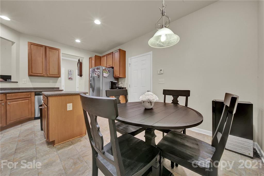 107 Inlet Point Drive Tega Cay, SC 29708 - Photo 6 of 24 a view of a dining room with furniture and wooden floor