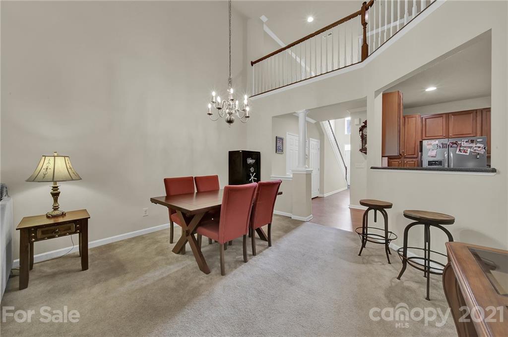 107 Inlet Point Drive Tega Cay, SC 29708 - Photo 8 of 24 a view of a dining room with furniture and chandelier