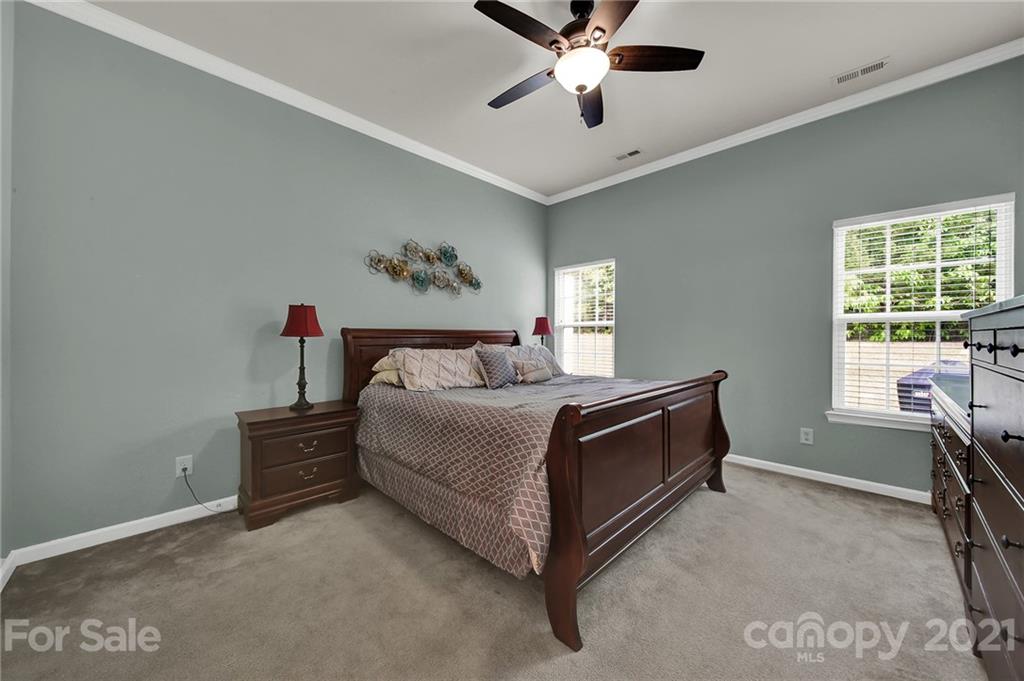 107 Inlet Point Drive Tega Cay, SC 29708 - Photo 10 of 24 a spacious bedroom with a bed and a window
