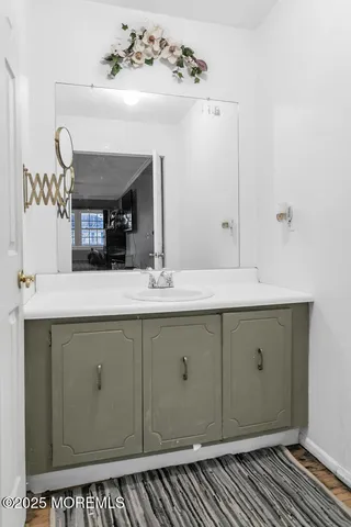 a bathroom with a sink vanity and a mirror