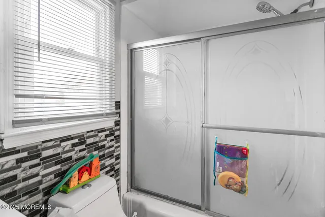 a utility room with a window and a shower