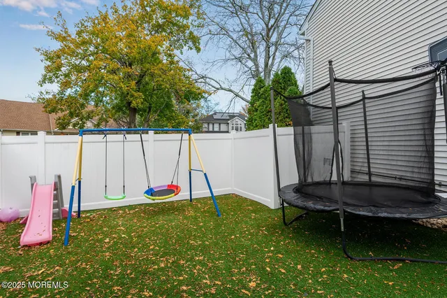 a backyard of a house with table and chairs