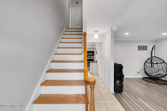 a view of entryway and hall with wooden floor