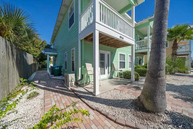 a view of a house with backyard and sitting area