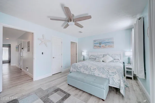 a bedroom with a bed and a ceiling fan