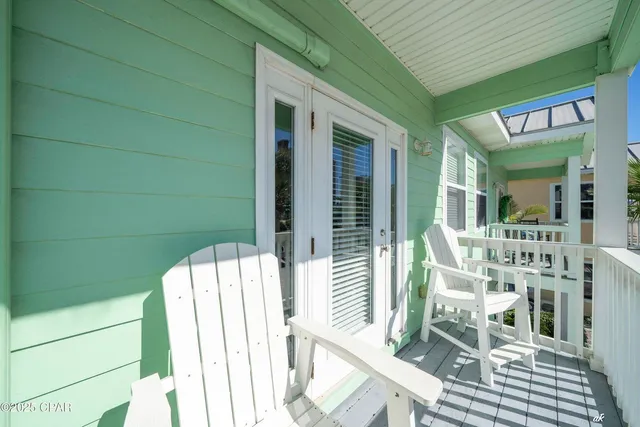 a view of balcony with furniture and wooden floor