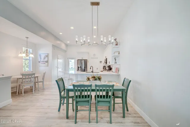 a view of a dining room with furniture and chandelier