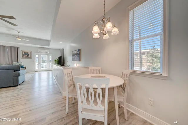 a view of a dining room with furniture wooden floor and chandelier