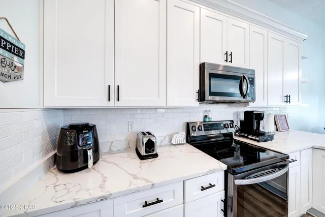 a kitchen with a sink and white cabinets