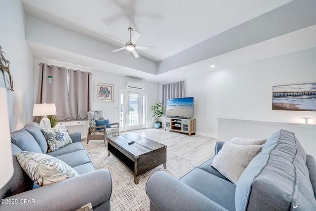 a living room with furniture a couch and a chandelier