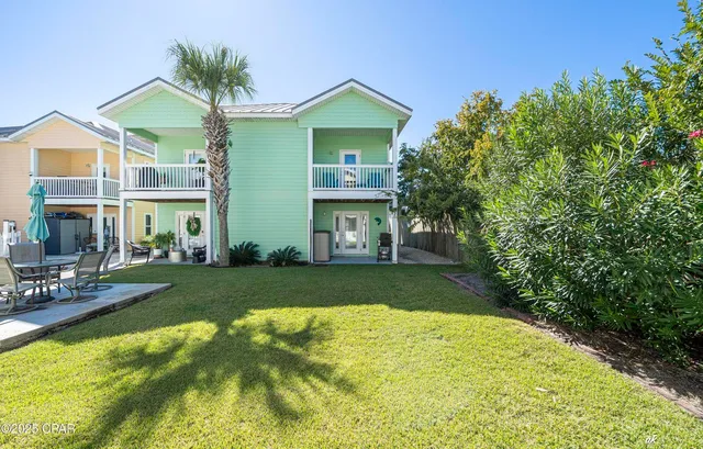 a front view of a house with a yard and porch