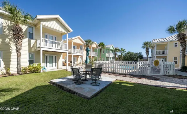 a view of a house with backyard and sitting area