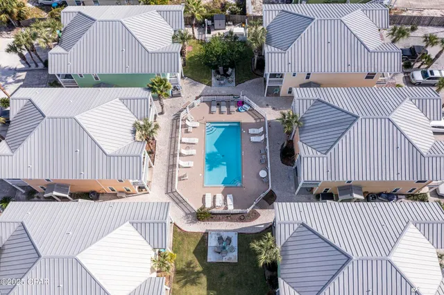 an aerial view of a house with swimming pool and sitting area